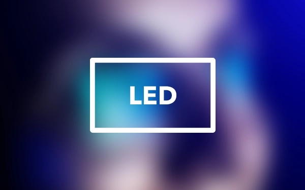 Значок зі словом LED на розмитому фоні — символ технології підсвічування в LED-телевізорах