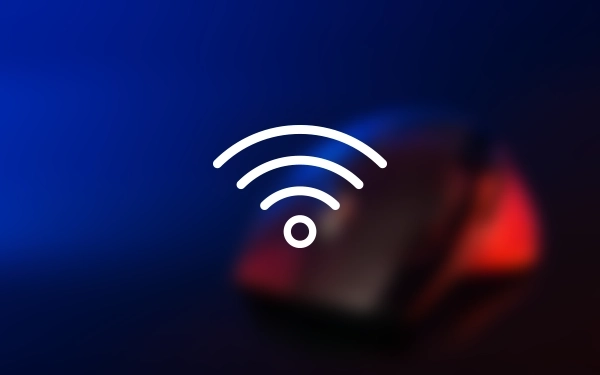 Значок бездротового сигналу Wi-Fi (Wireless Fidelity) на розмитому фоні комп'ютерної миші синім та червоним світлом.