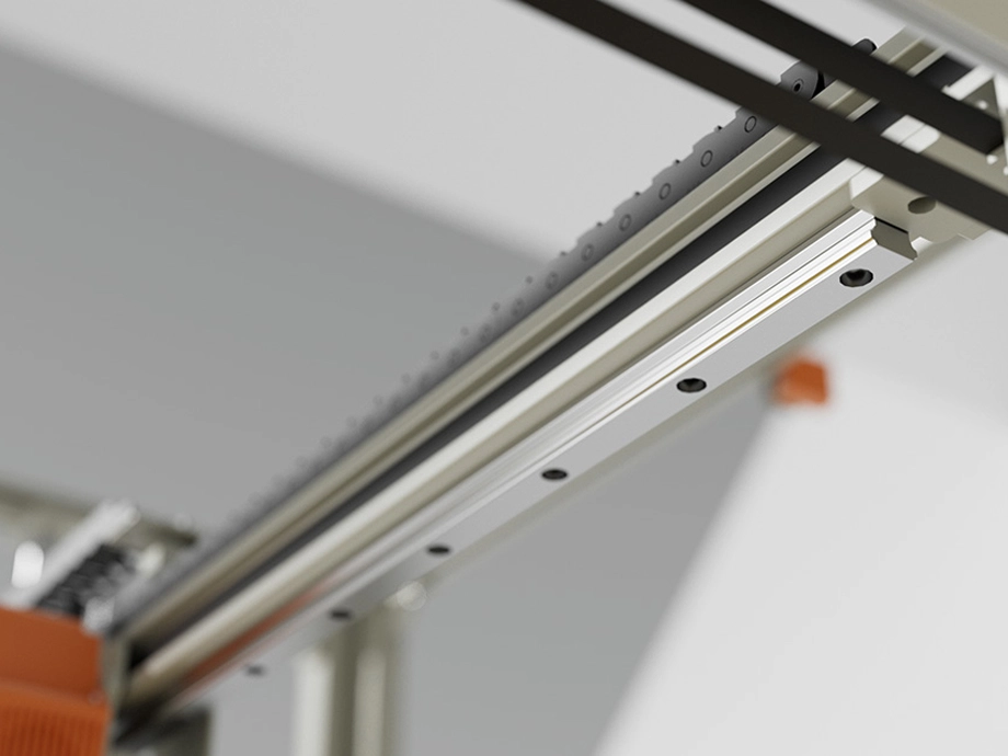 Деталь напрямного механізму 3D-принтера з видимими металевими рейками та напрямними.